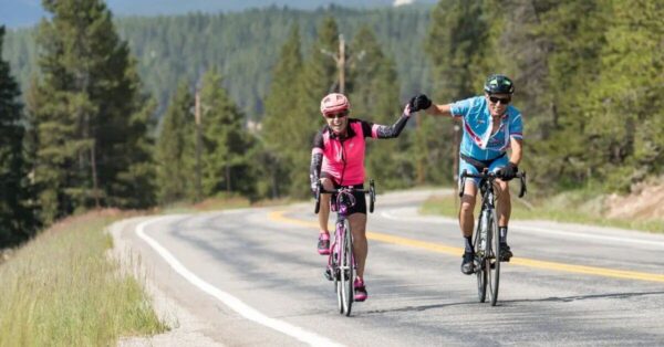 Cyclists celebrate their ride with a fist bump