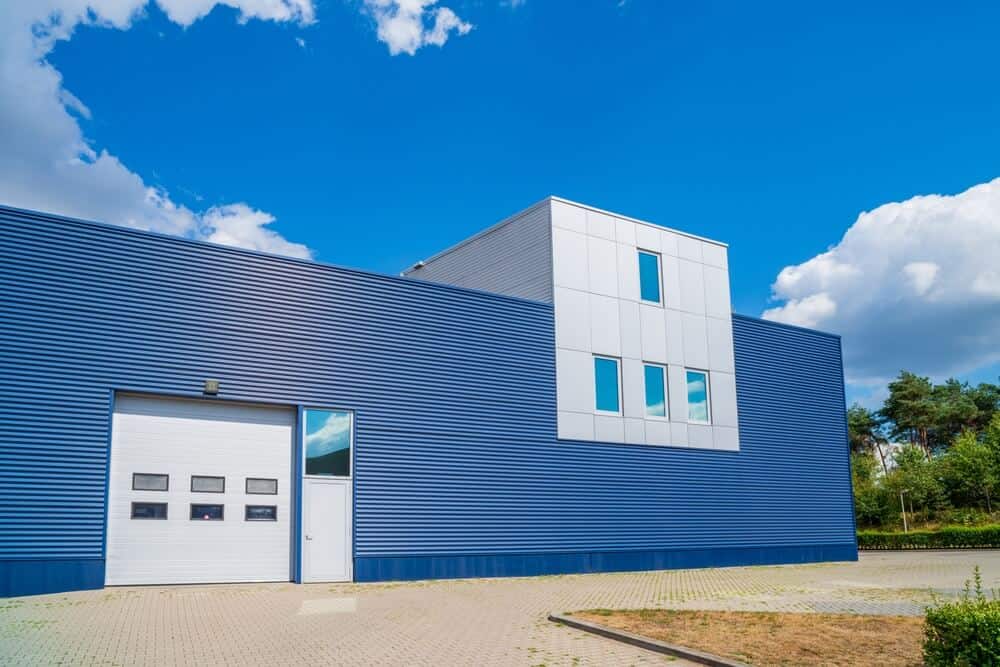 Exterior shot of a blue warehouse building with modern design and blue skies