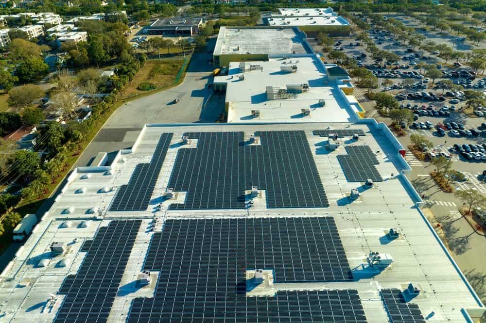 A commercial roof system with a solar panel system on a shopping center roof.