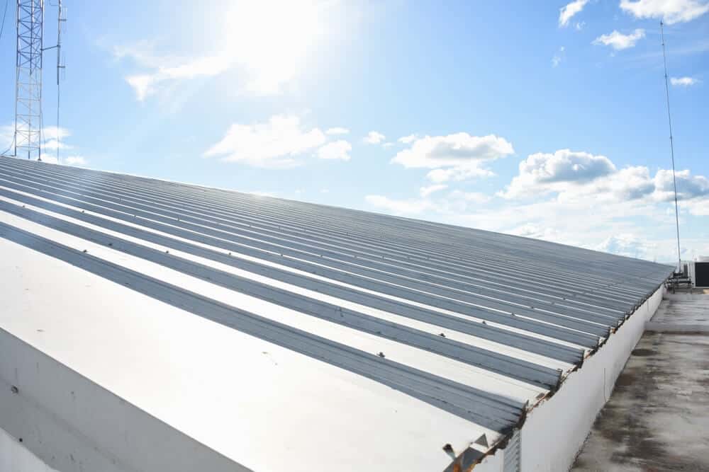 A metal roof on a commercial building on a clear, cold winter day.