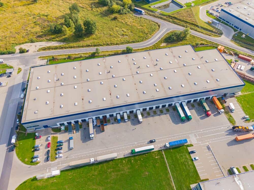 A gray single-ply roofing system installed on a large warehouse roof.