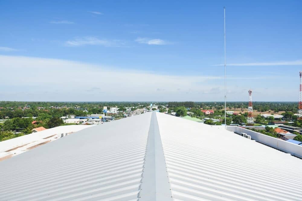 A metal roof installed on a sloped commercial roof with the horizon in the background.