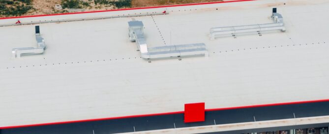An aerial view of a PVC commercial roof highlights clean seams, HVAC equipment, and a well-installed membrane